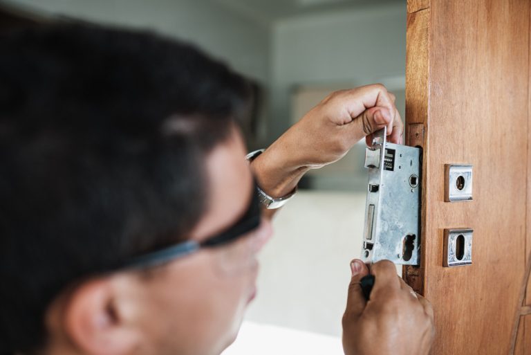 close-up-male-hands-repair-installing-metal-door-lock