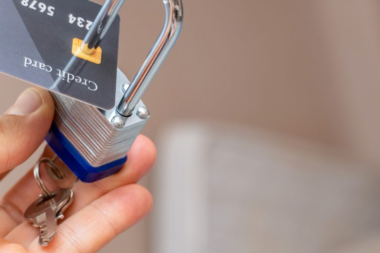 plastic-credit-card-locked-with-metal-padlock-close-up